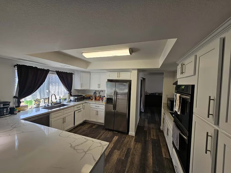 Modern shared kitchen with white cabinets and large counters